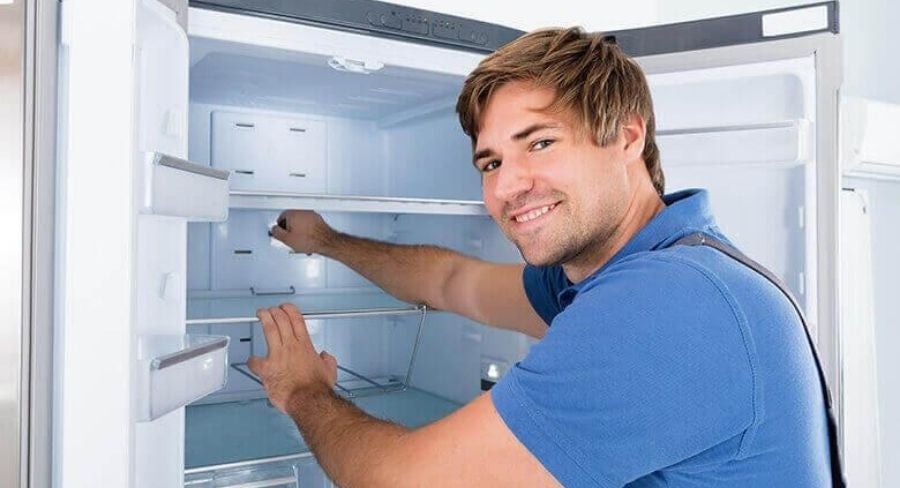 Técnico realizando mantenimiento de la nevera